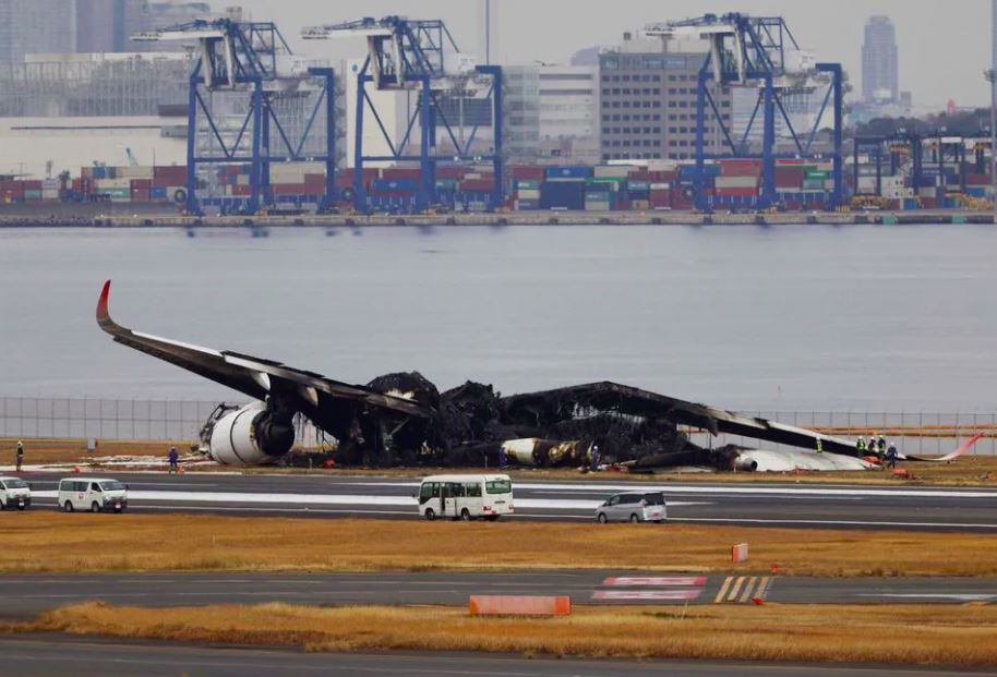 An aerial view shows burnt Japan Airlines' (JAL) Airbus A350 plane after a collision with a Japan Coast Guard aircraft at Haneda International Airport in Tokyo,