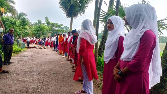Students Form Human Chain Demanding Road Repairs in Jhalakathi